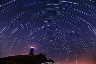 timelapse photography of star and lighthouse