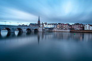 gray concrete bridge on body of water connected with City street, maastricht HD wallpaper