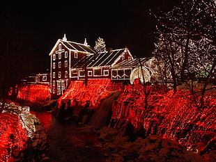brown house with string lights during nighttime