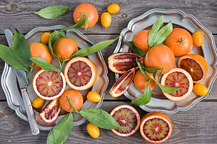 bunch of orange fruits on two plates HD wallpaper