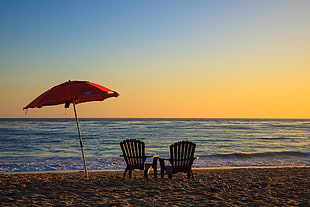 two brown armchairs, beach, sunset, sea, sand