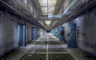 gray concrete building, prisons, abandoned