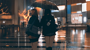 two woman under black umbrella during rain