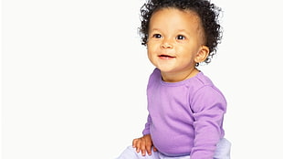 black-haired toddler in purple long-sleeved shirt and white pants outfit