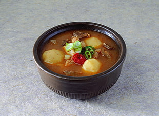 black ceramic bowl with beef and potato