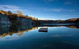brown wooden pallet on body of water