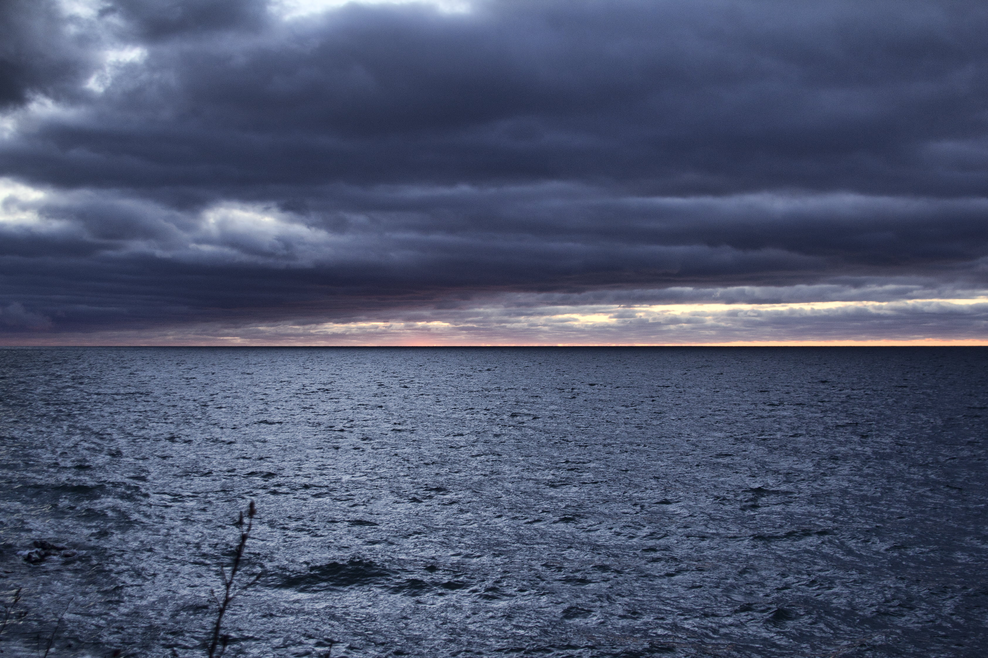 sea under black cloudy sky