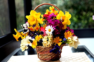 variety of flowers in basket