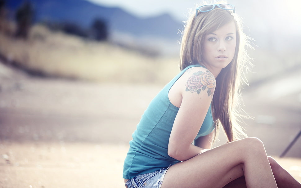woman in teal tank top and blue shorts sitting down HD wallpaper