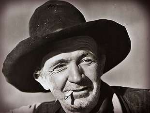 gray scale photo of man wearing cowboy hat