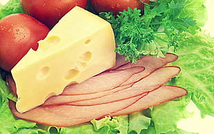 sliced cheese and ham with lettuce and red tomatoes