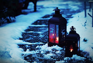 two black candle lanterns, snow, Christmas ornaments , candles