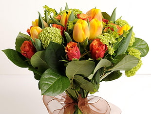 closeup photo of bouquet of yellow tulips and red roses