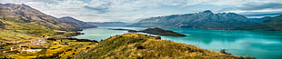 blue body of water between green mountains during daytime HD wallpaper