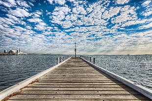 photo of beige wooden sea dock during daytime