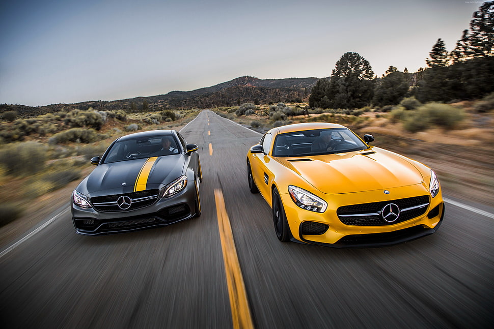 two yellow and black Mercedes-Benz sports cars HD wallpaper