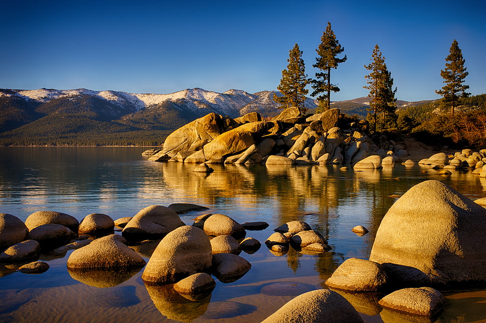 photographed of stone on body of water HD wallpaper