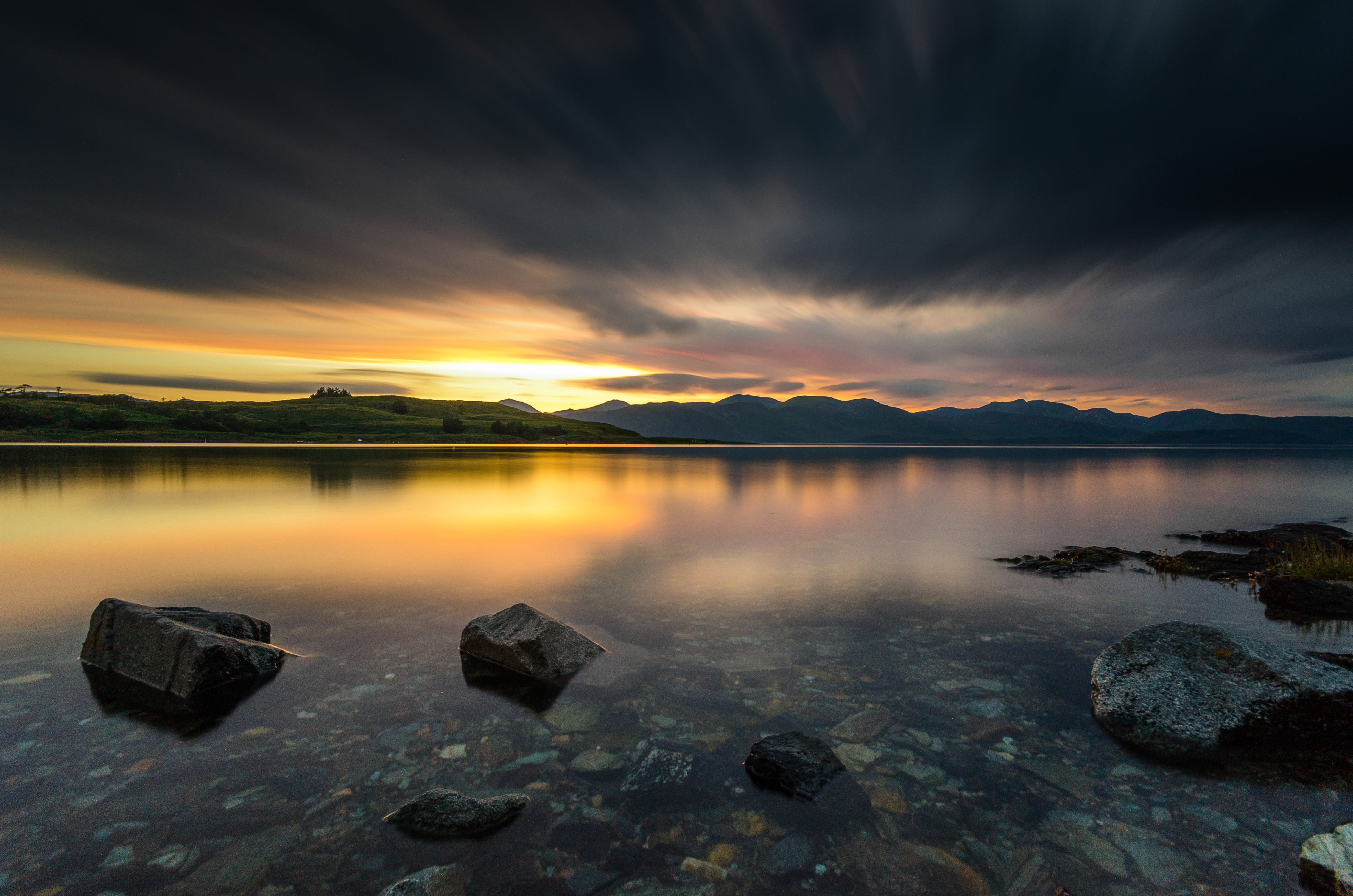 time lapse photography of body of water under cloudy sky