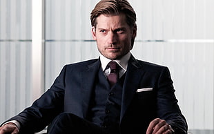 man wearing black formal suit with brown necktie