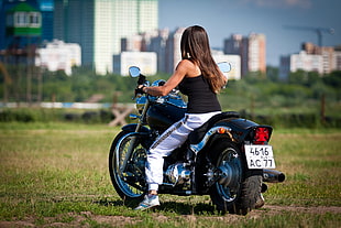 woman in black tank top riding motorcycle