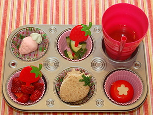 gray cupcake pan with strawberries