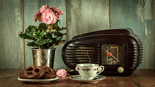 black vintage radio on brown wooden table
