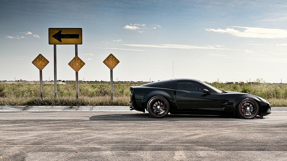 black Chevy Corvette Stingray at the road during daytime HD wallpaper