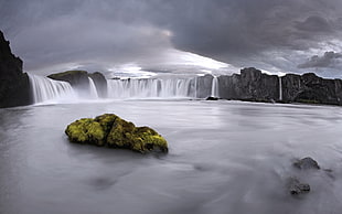 water falls under black cloudy sky HD wallpaper