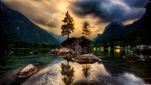 bodies of water covered with mountain under cloudy skies HD wallpaper