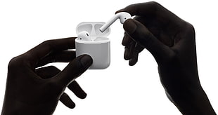 person holding white Apple AirPods HD wallpaper