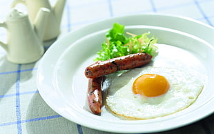 sausage and egg on white ceramic plate