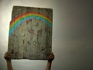 brown wooden rainbow print board