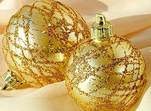 close-up photo of two gold-colored baubles
