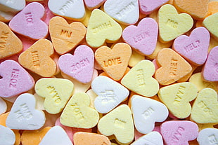close-up photo of heart-shaped assorted print candies HD wallpaper