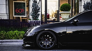 black car parked in front of store HD wallpaper