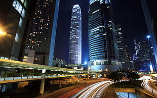 time lapse photography of city with high rise buildings at nighttime