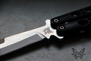 black handled stainless steel Benchmade butterfly knife closeup photography