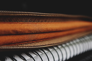 closeup photography of brown zip bag