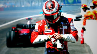 man in F1 car suit and helmet