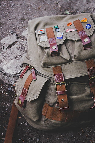 gray and brown buckle-strap backpack