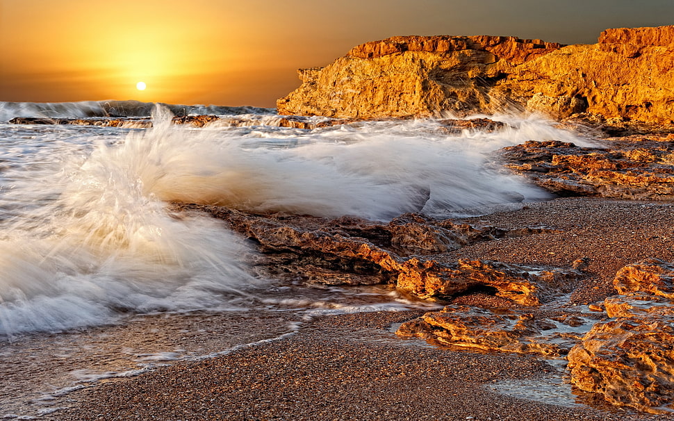 time lapse photography of seashore splashing wave to the rock HD wallpaper