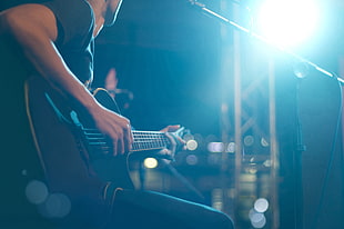 black electric guitar, guitar, lights, microphone, playing