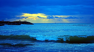 waves overlooking island during twilight
