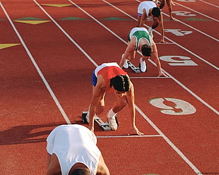 runners at starting line at running track HD wallpaper