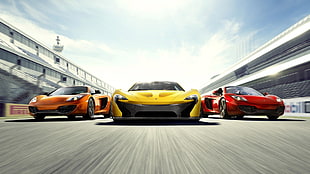 orange, yellow and red sports cars racing on asphalt road illustration