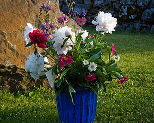 assorted flowers in blue vase
