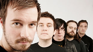 five men wearing black shirts
