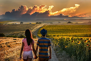 couple holding hands waking on the road