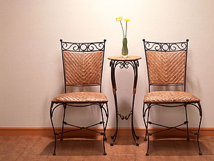 two brown padded dining chairs]