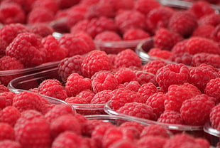 raspberries on glass bowls